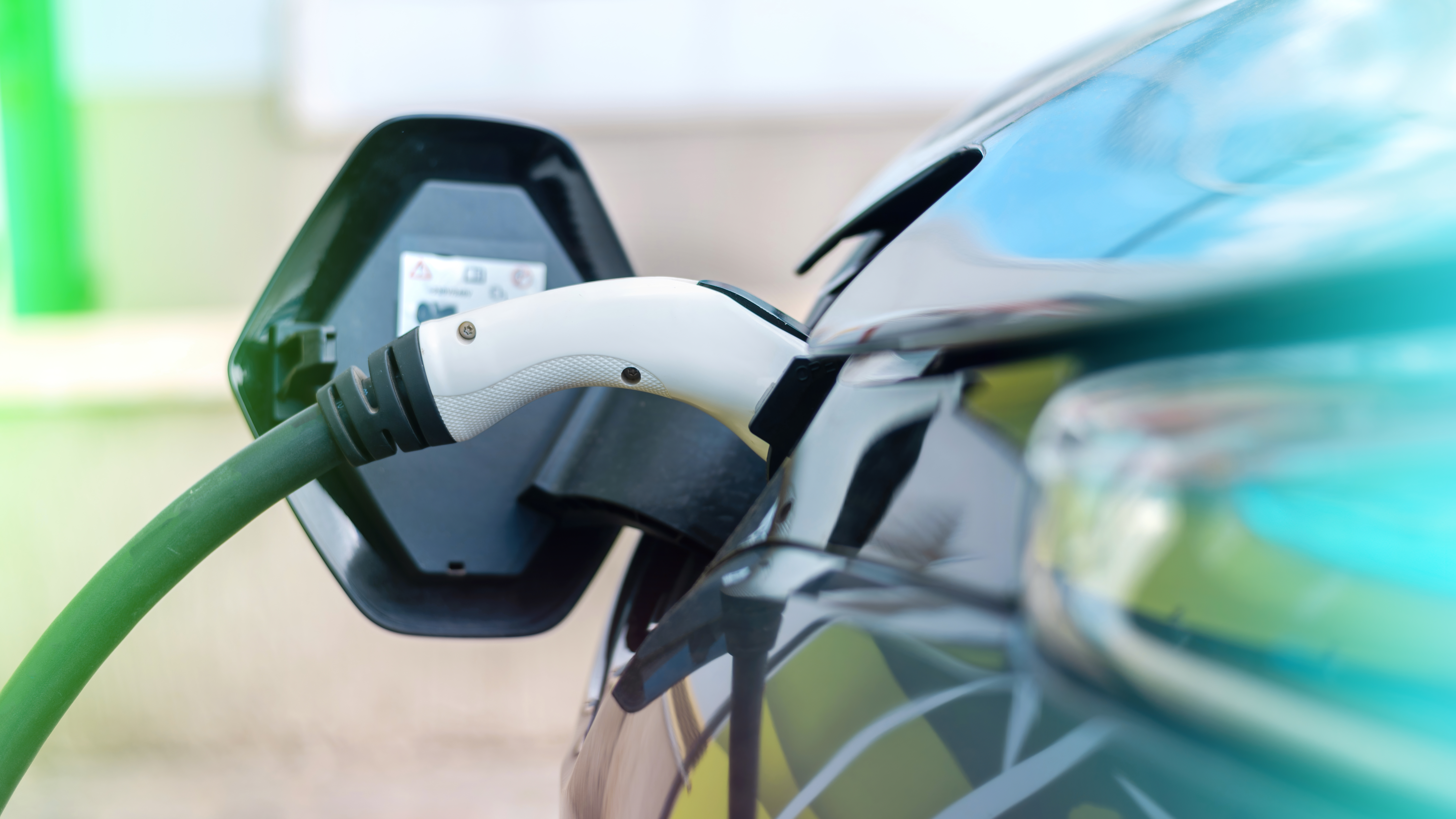 Electric vehicle plugged in and charging at a beachfront property in Hervey Bay