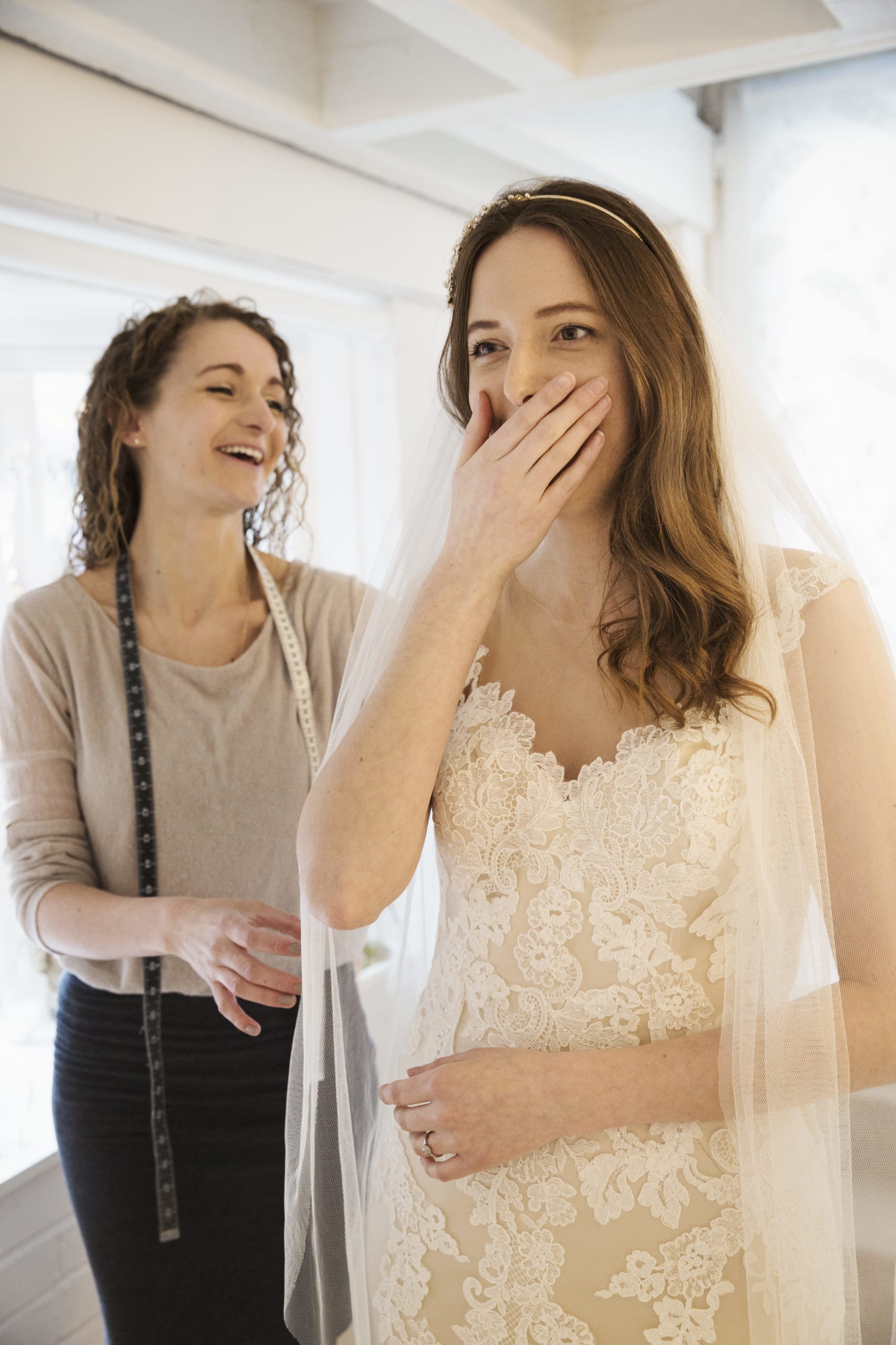 a-young-woman-trying-on-a-wedding-dress-with-lace-2021-08-29-08-19-37-utc