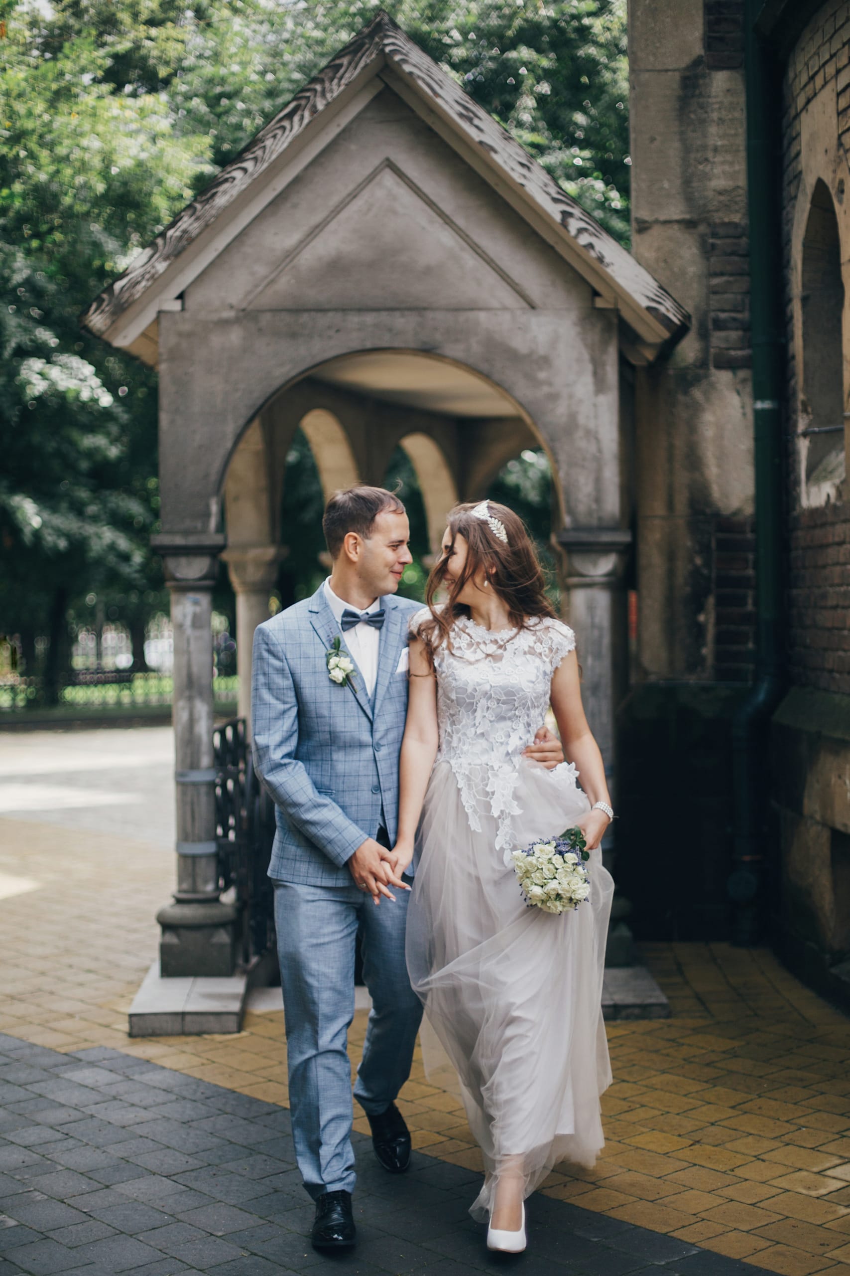 stylish-happy-bride-and-groom-walking-on-backgroun-2022-08-18-17-01-57-utc