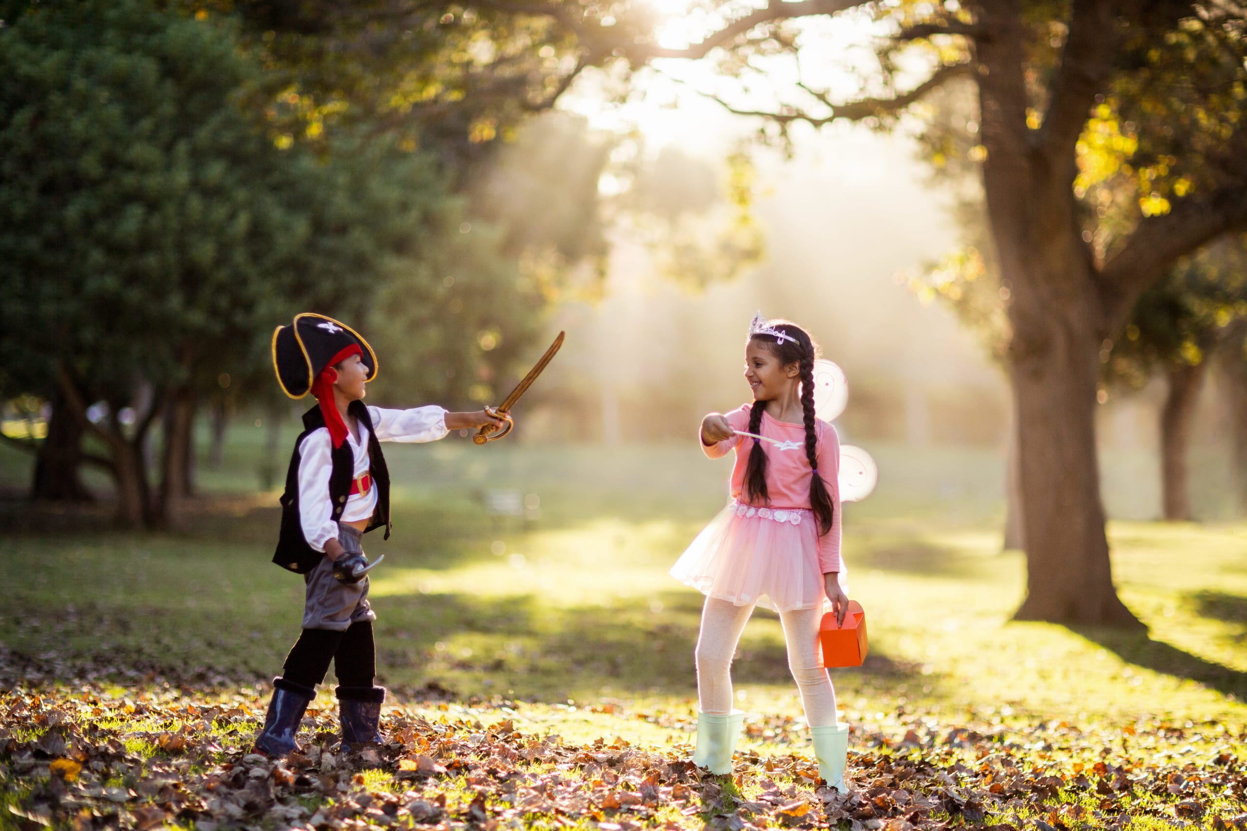 playful-siblings-wearing-costumes-at-park-2021-08-28-17-24-01-utc