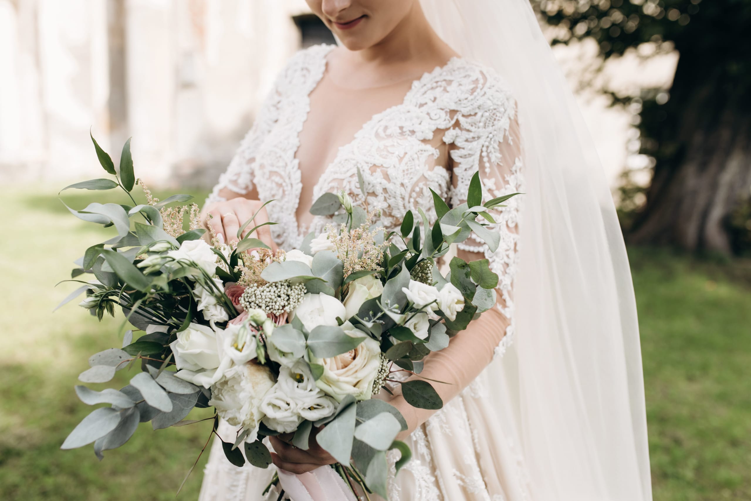 bride-beautiful-dress-holds-bridal-bouquet-with-greenery-decor-branches-white-roses
