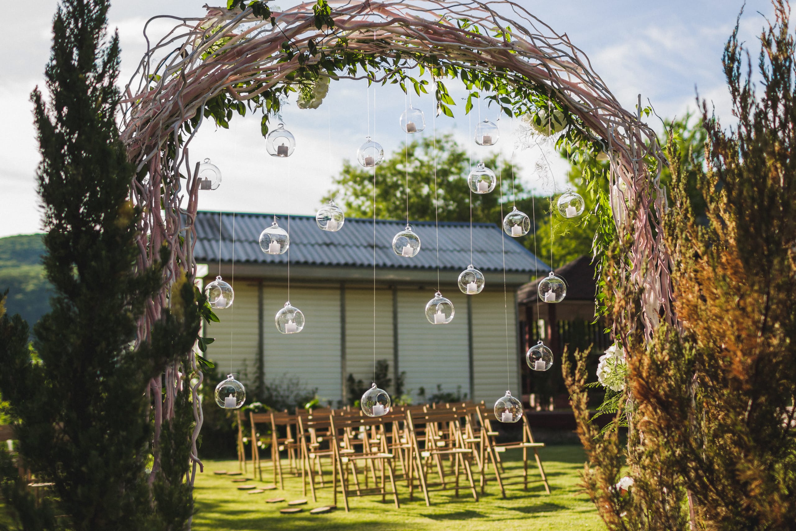 evening-wedding-ceremony-in-garden-arch-with-whit-2022-02-01-22-37-10-utc