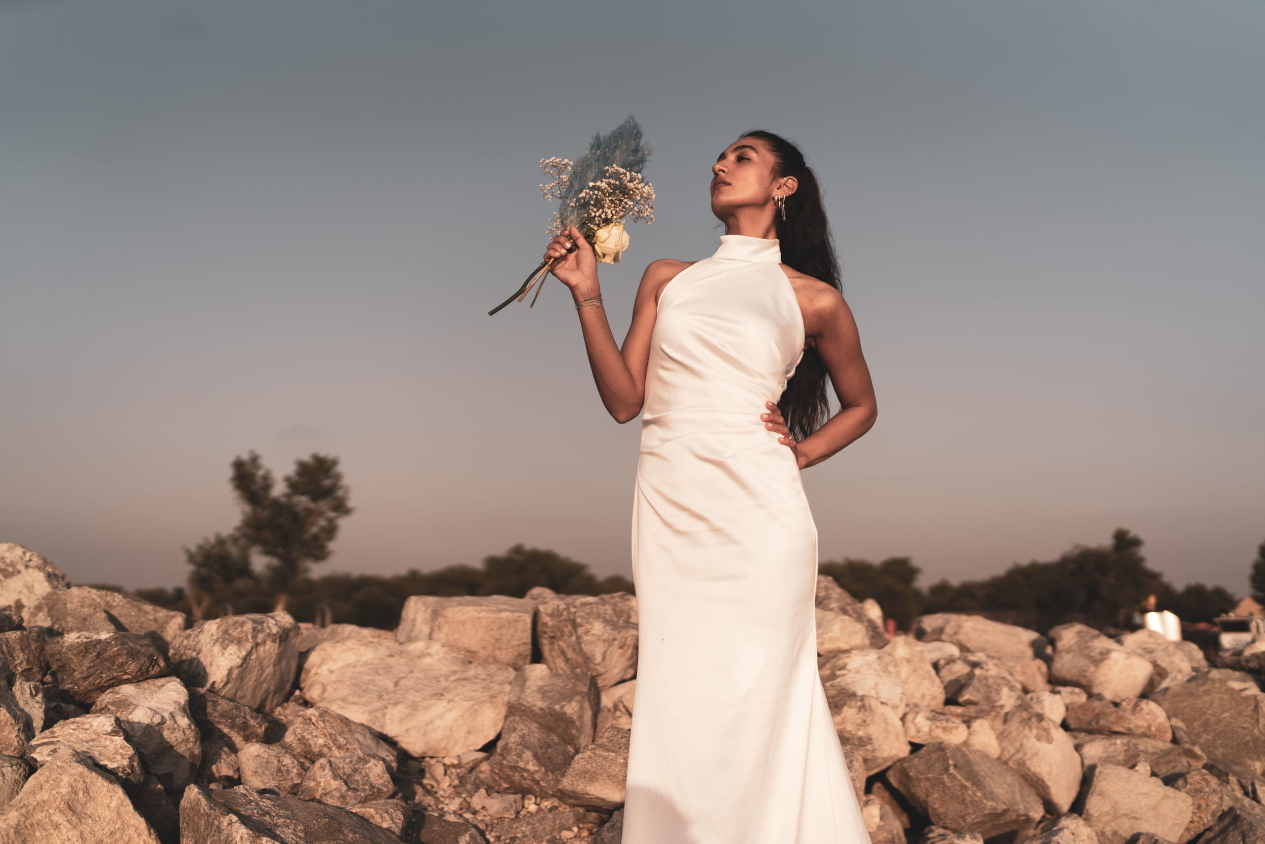bride-with-bridal-bouquet-standing-on-rocks-2022-01-18-23-51-51-utc