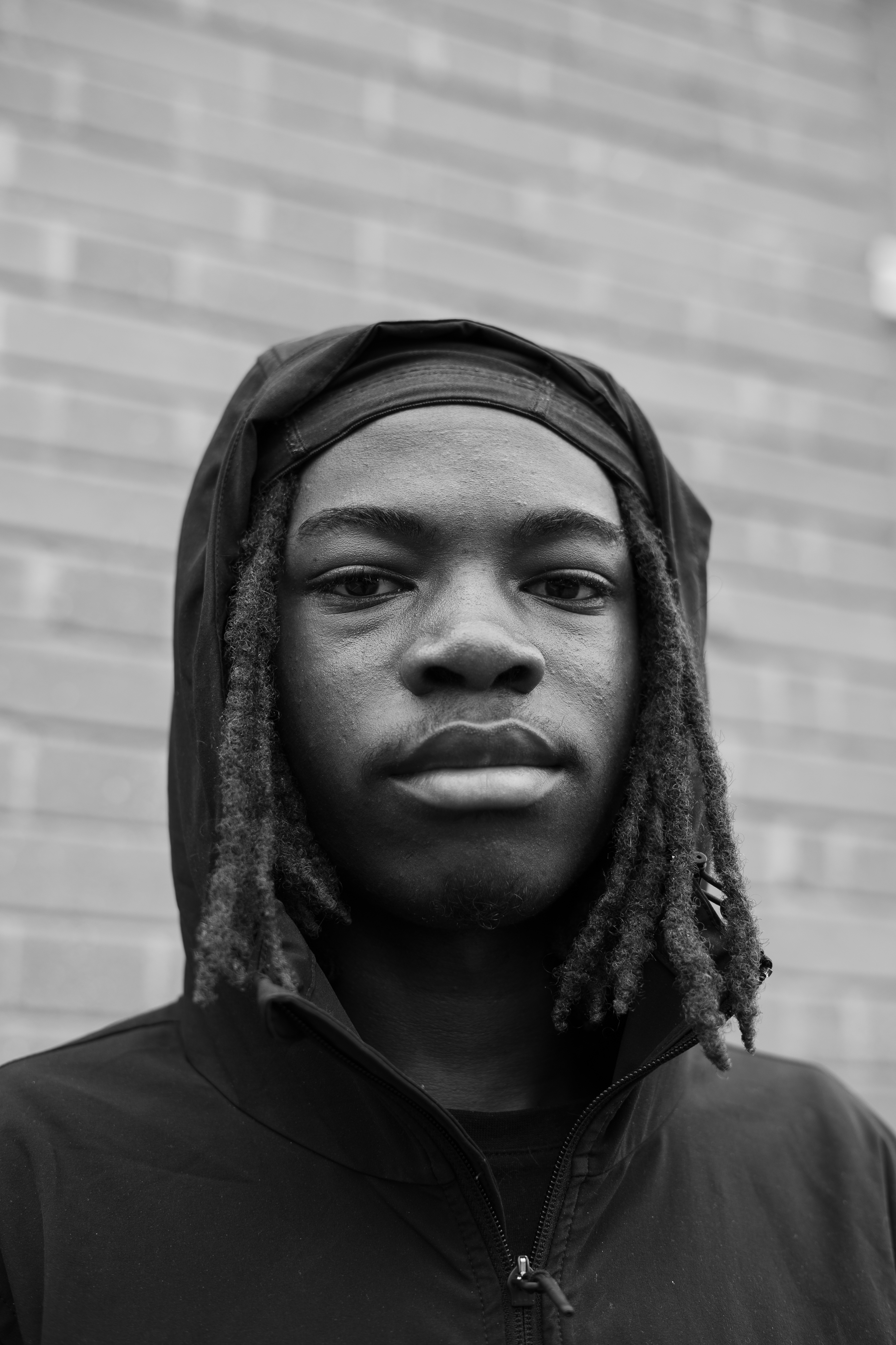 A very close up black and white portrait of Shubomi, he is looking slightly down into the camera.
