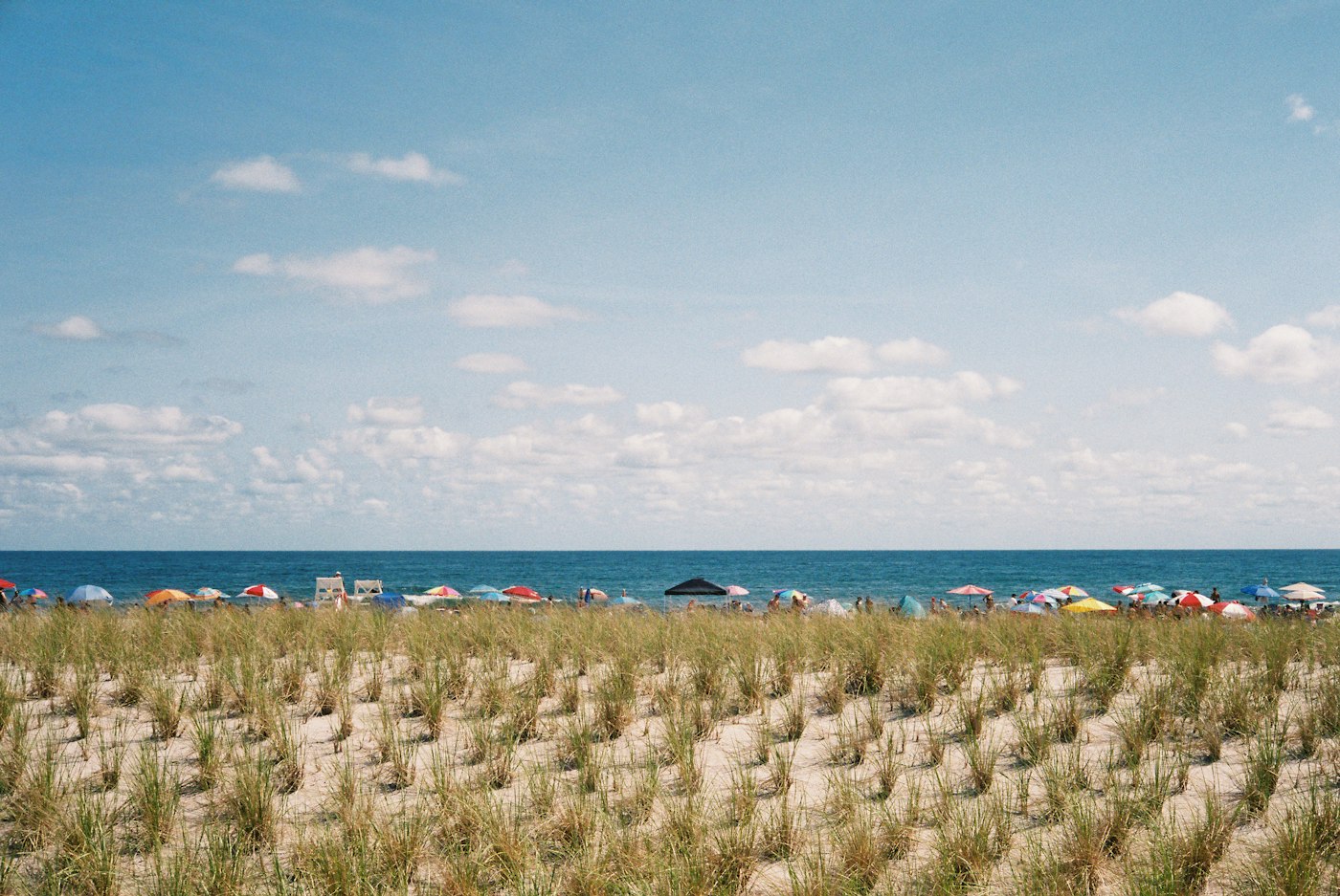 a beach with rocks and people