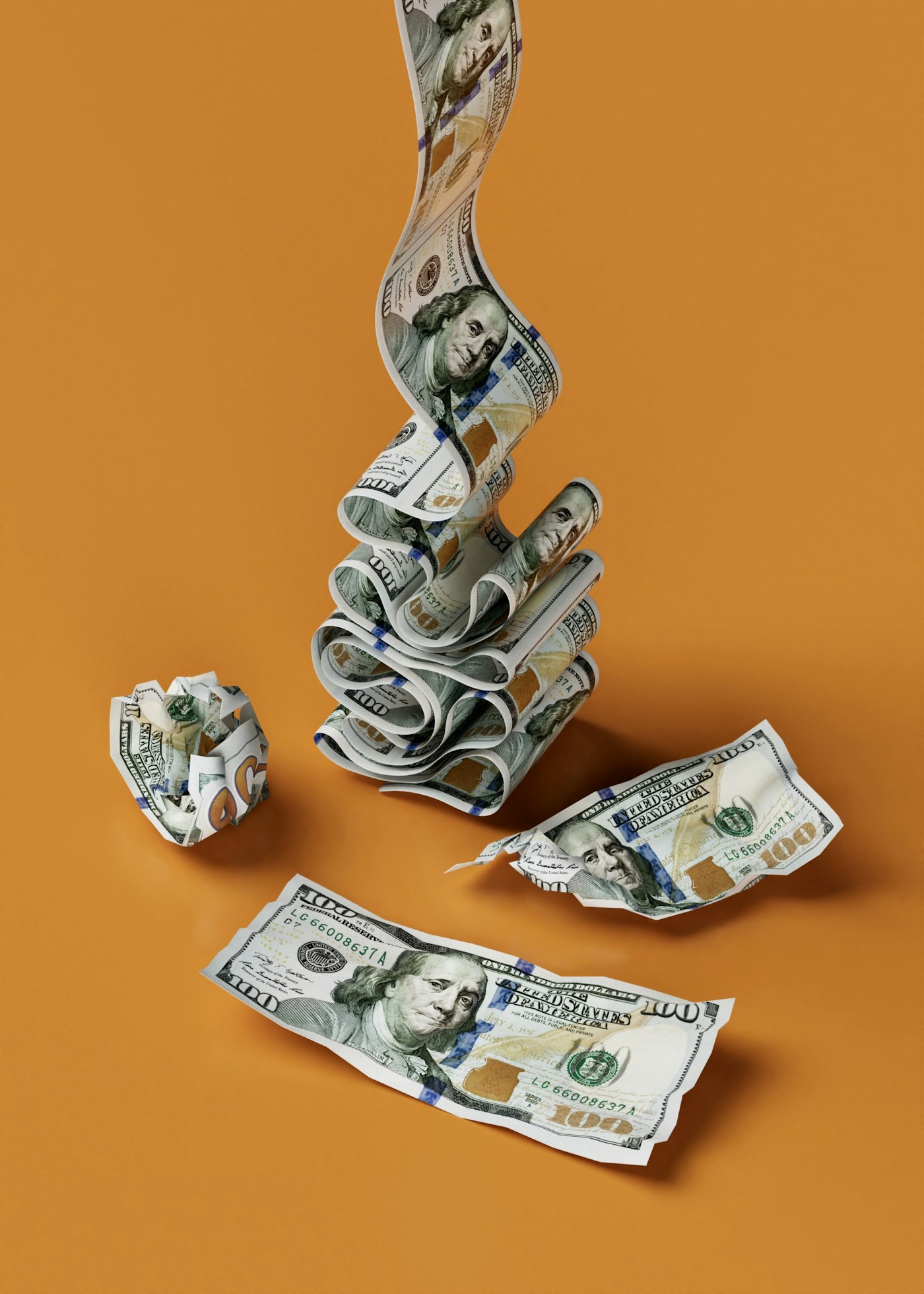 A spiraling stack of hundred dollar bills with crumpled banknotes on an orange surface