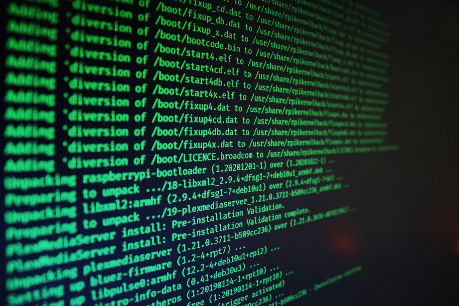 Green computer code scrolling on a dark screen