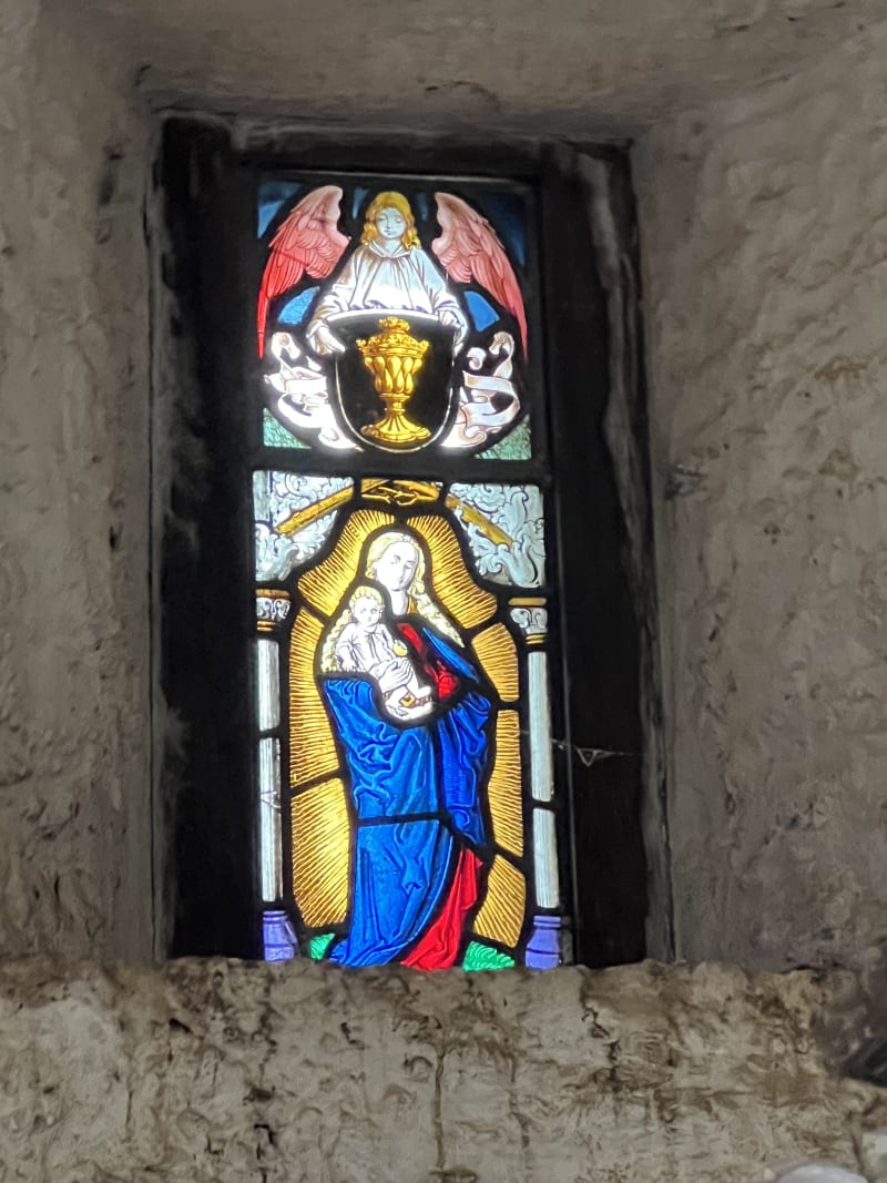 Colourful stained-glass window set into a Castle Matrix wall