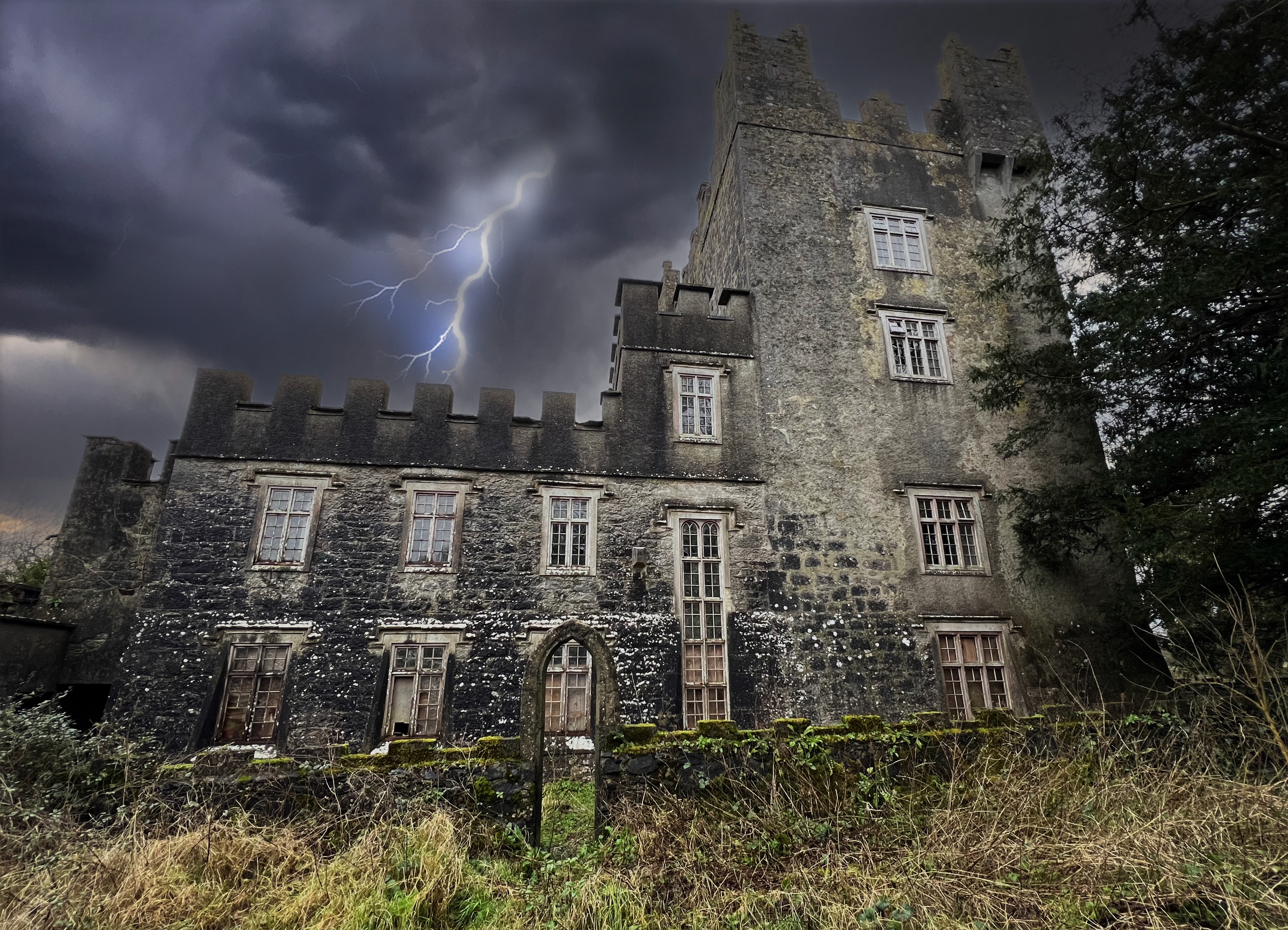 Castle Matrix tower under lightning, side view