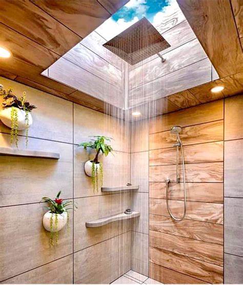 Shower trends 2024 featuring natural and organic elements, with wood-inspired walls, lush greenery, a rainfall showerhead, and a skylight for a spa-like bathroom retreat."