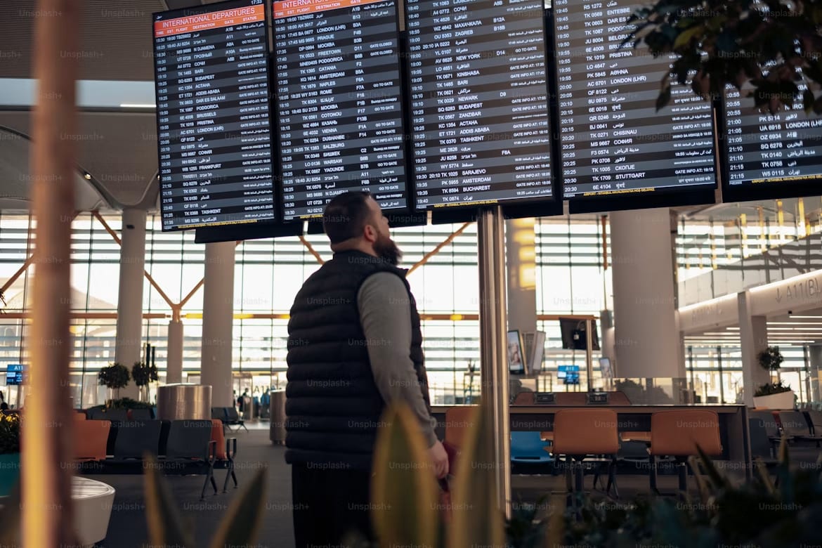 Photo of man looking into Info Table Screen in Terminal.