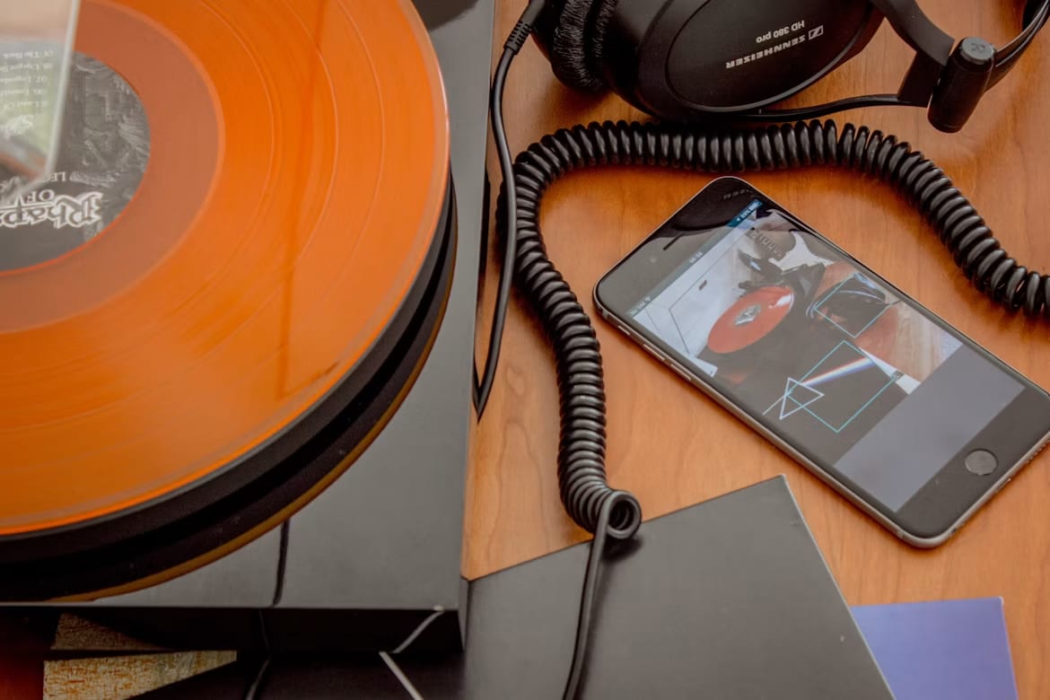 Headphones resting on a vintage cassette tape and retro player, evoking past memories through music.