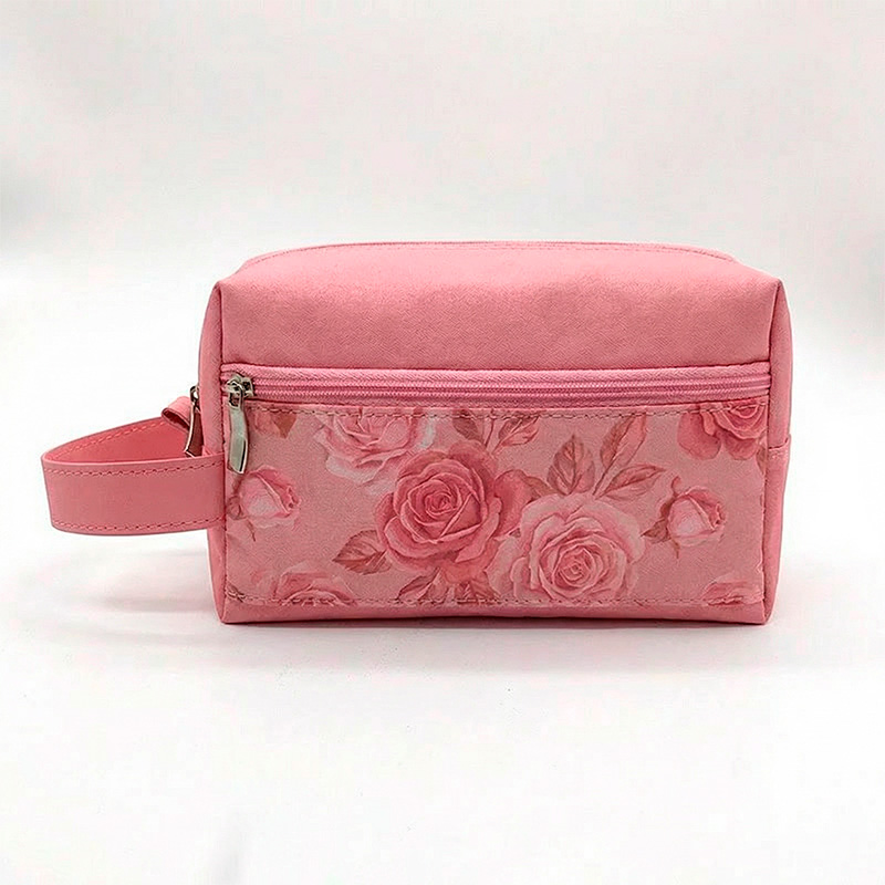 uma necessaire rosa tom sobre tom com com estampa de rosas no bolso, frontal.