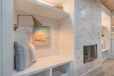 Cozy nook with cushion and fireplace