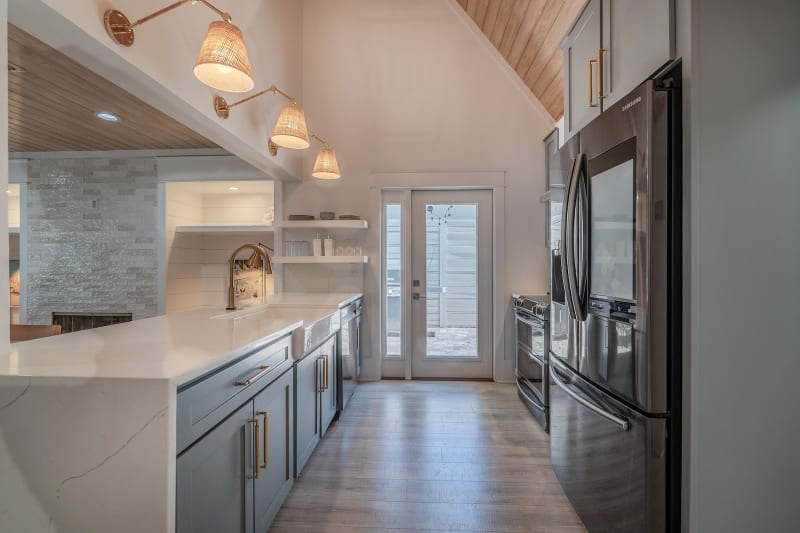 Modern kitchen with wooden ceiling and lights