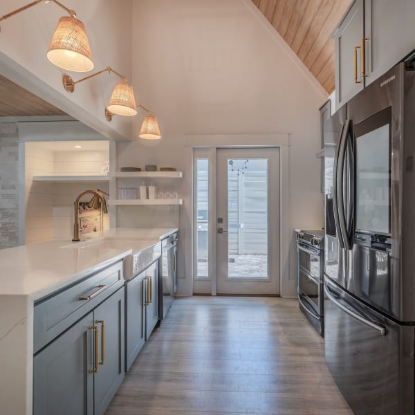 Modern kitchen with wooden ceiling and lights