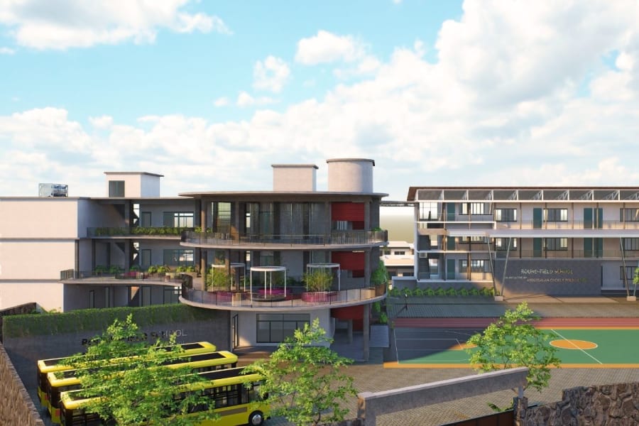 Exterior of Round Field School by URU Consulting — campus context