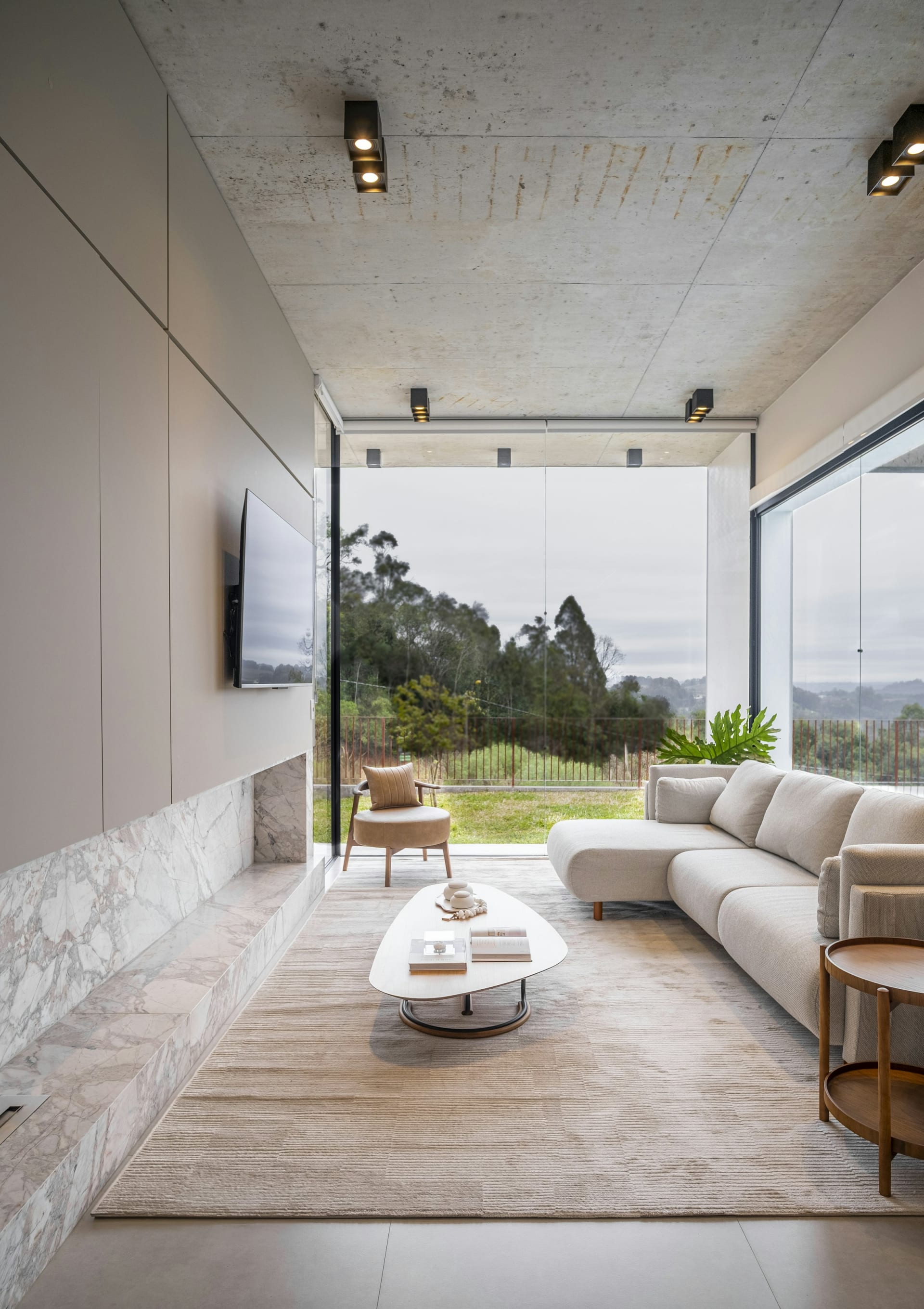 A tranquil Boise living room with high ceilings and large windows showing a mountain landscape