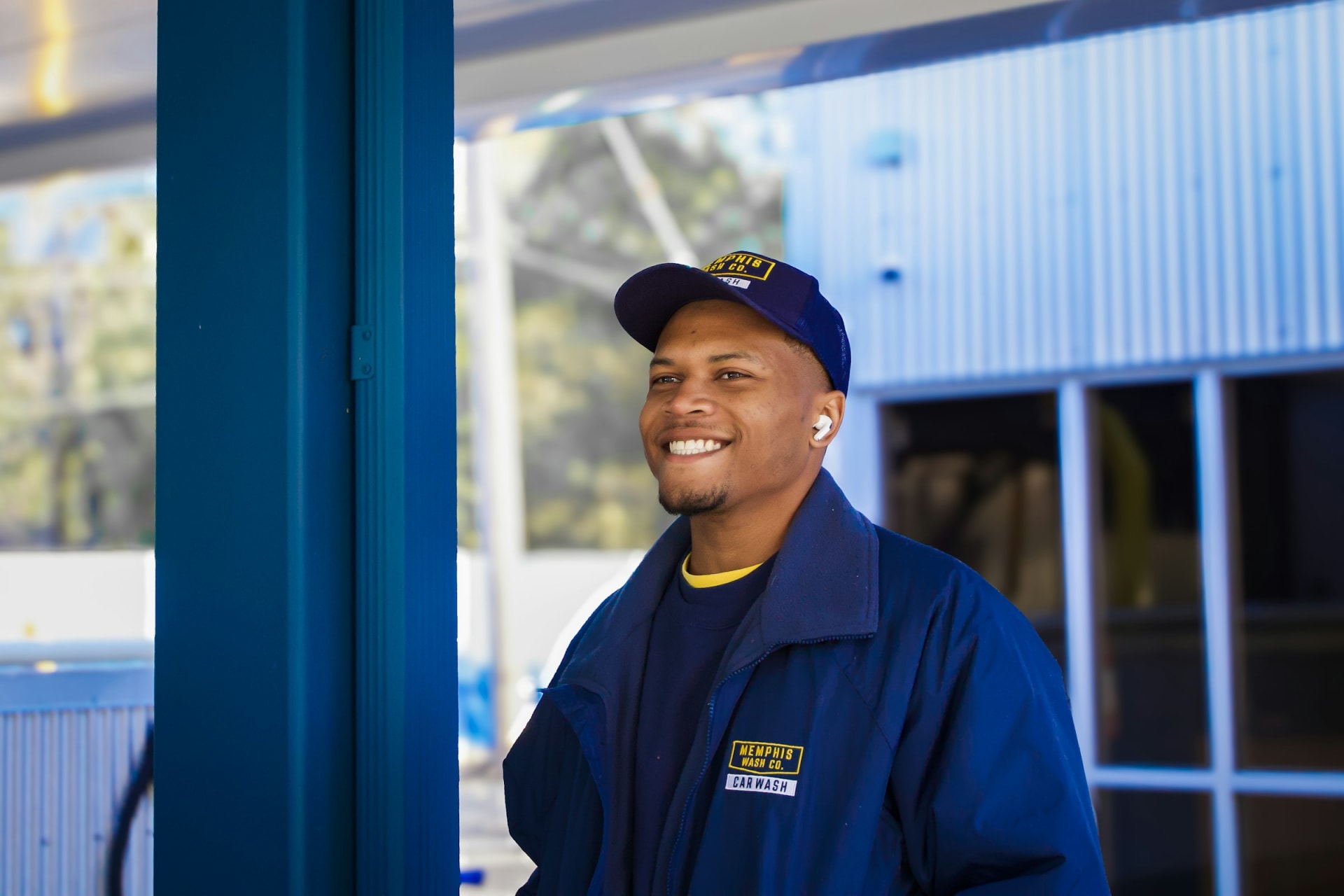 A professional HVAC technician in a clean blue uniform inspecting a furnace in a Boise home basement