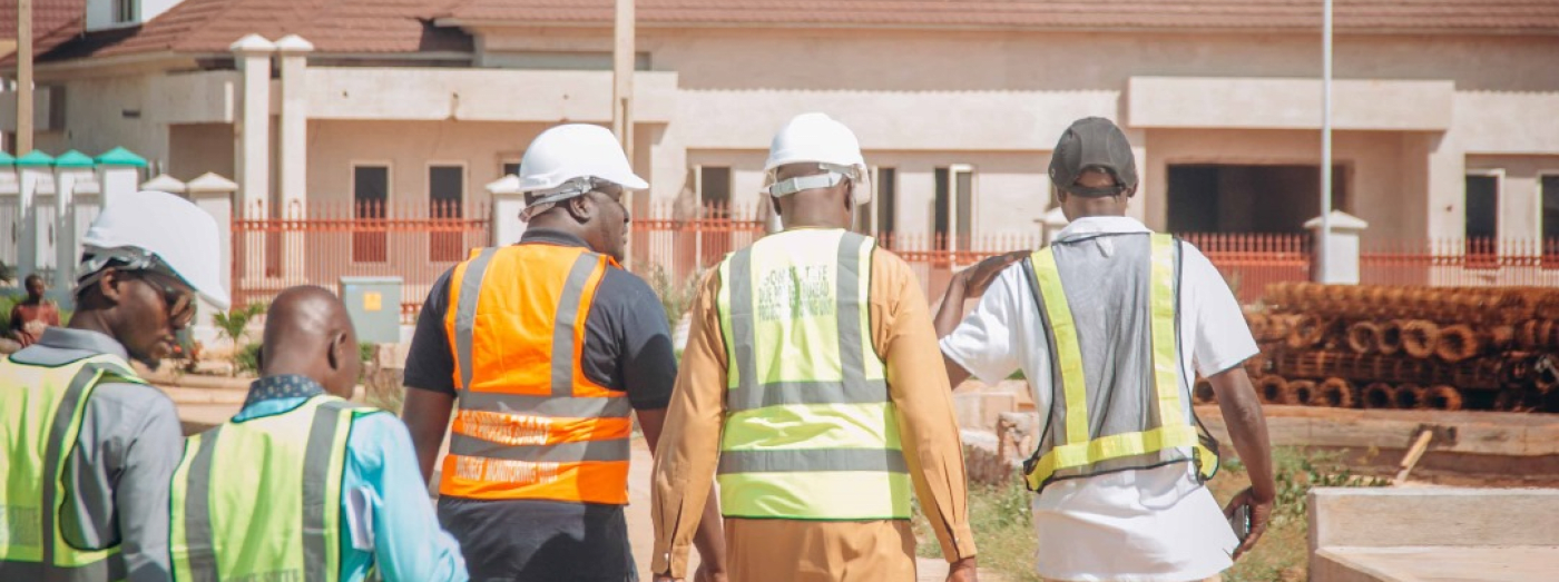 General Director with his team walking to a completed government building