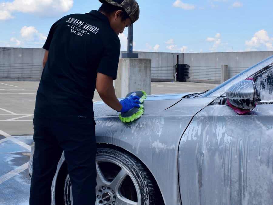Supreme Nomads washing a car on a parking deck in the Charlotte metro