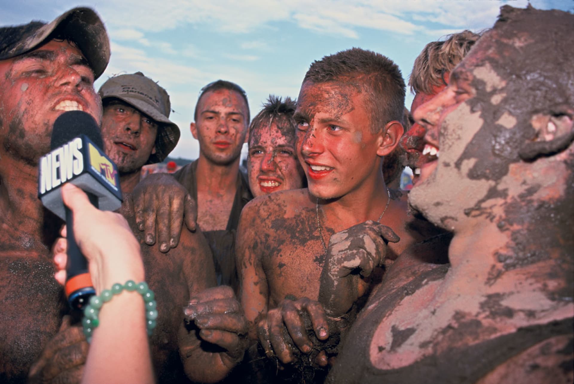 Festivalgoers covered in mud and human waste. Festivalgoers covered in mud and human waste.