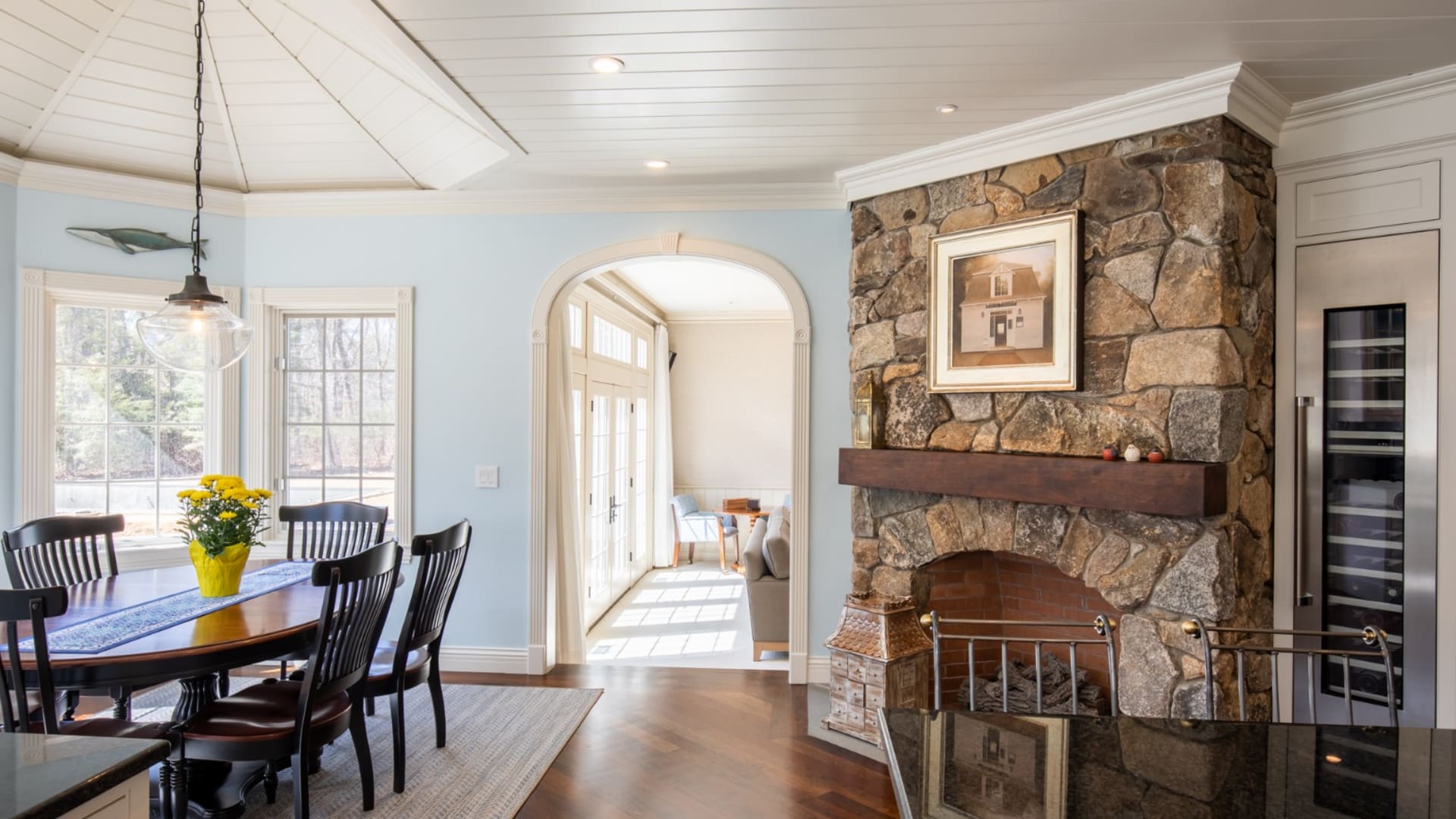 Breakfast nook and stone fireplace off kitchen