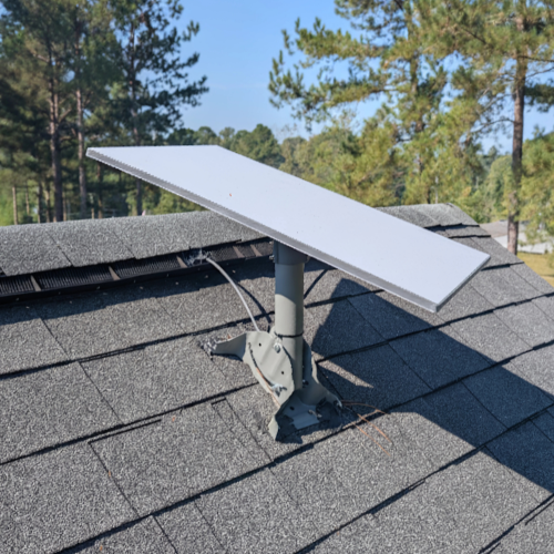 Satellite dish installed neatly on the side of a house