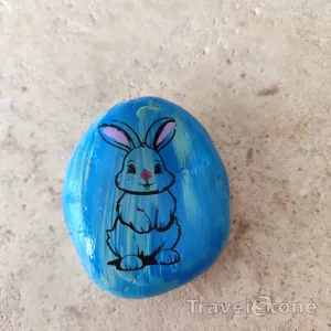 Painted painting stone by artist CJ showing animals. Bunny TravelStone.