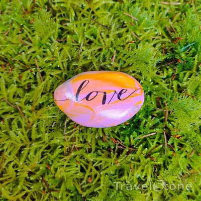 Painted painting stone by artist Ella showing sayings. all about love.