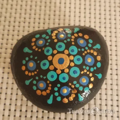 Painted dotting stone by artist Yumi showing pattern. Mandala.