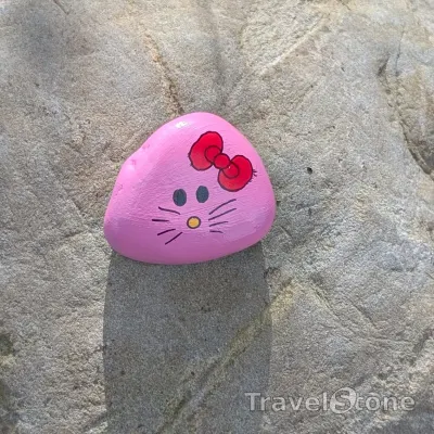 Painted painting stone by artist CJ showing comic. Hello Kitty stone :-).