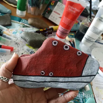 Painted painting stone by artist comfortinstones showing other. Red shoe.