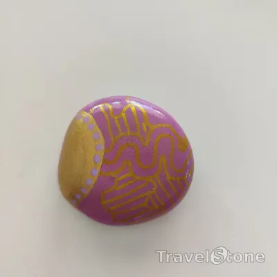Painted painting stone by artist Ella showing pattern. Copper and pink painted stone.