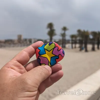 Painted painting stone by artist LaLiLu showing pattern. Colorful star.