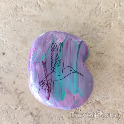 Painted painting stone by artist CJ showing animals. One more bird TravelStone.