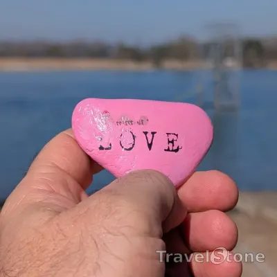 Painted painting stone by artist 007 showing sayings. Pink love.