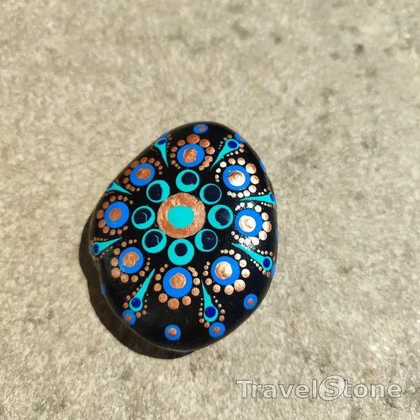 Painted dotting stone by artist CJ showing pattern. Mandala.
