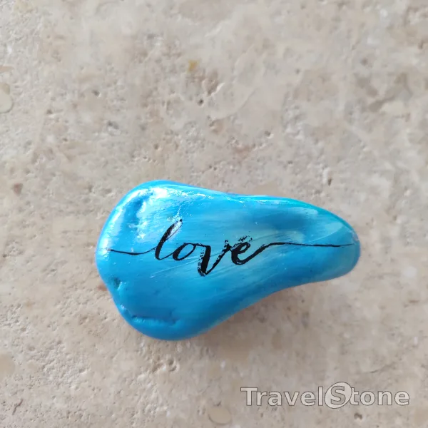 Painted painting stone by artist CJ showing sayings. Love TravelStone