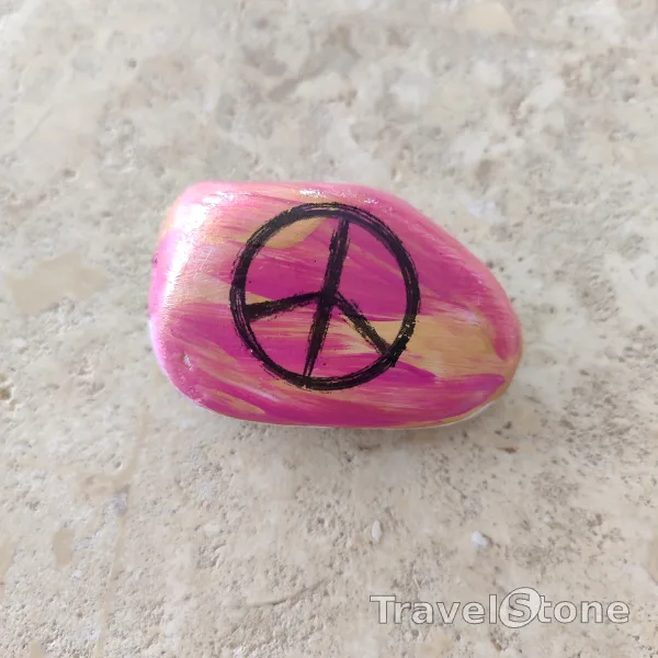 Painted painting stone by artist CJ showing fantasy. Peace TravelStone