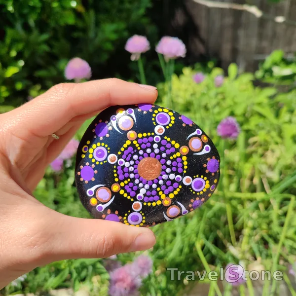 Painted dotting stone by artist CJ showing pattern. Mandala. Acrylic Paint and dotting tools