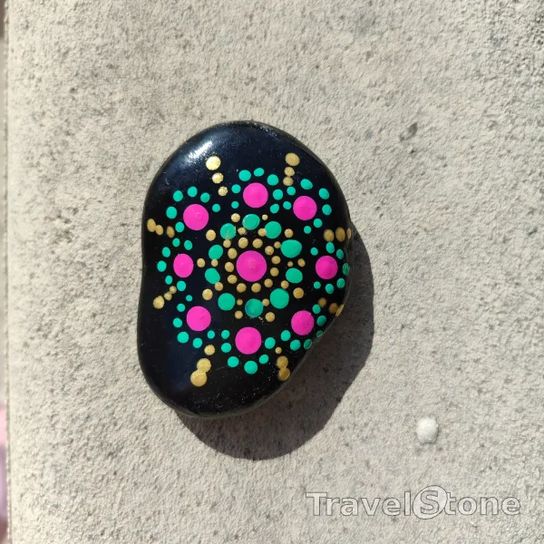Painted dotting stone by artist CJ showing pattern. Mandala TravelStone
