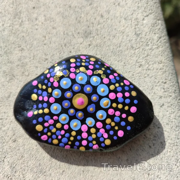 Painted dotting stone by artist CJ showing pattern. Mandala TravelStone