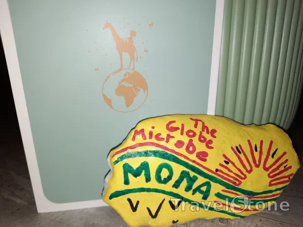 Painted painting stone by artist Armani showing special occasion. Mona's name whispers in the wind - eager to travel the world