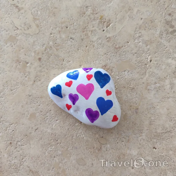 Painted painting stone by artist CJ showing pattern. Hearts TravelStone