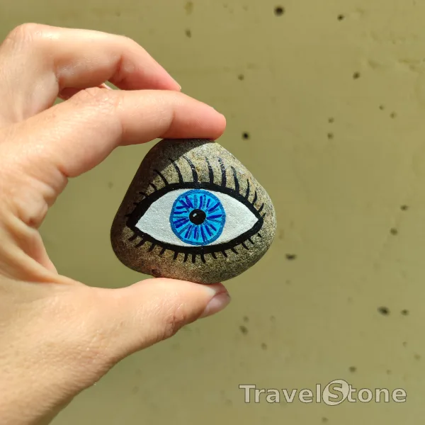 Painted painting stone by artist 007 showing fantasy. In the eye of a TravelStone