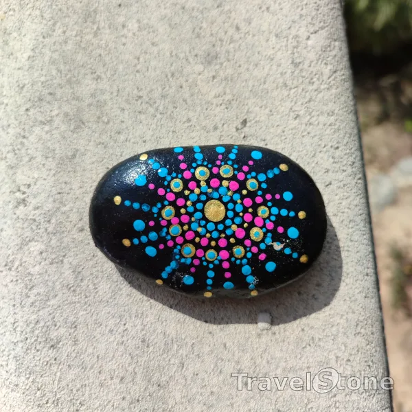 Painted dotting stone by artist CJ showing pattern. Mandala TravelStone
