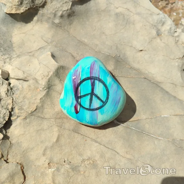 Painted painting stone by artist CJ showing fantasy. Peace TravelStone