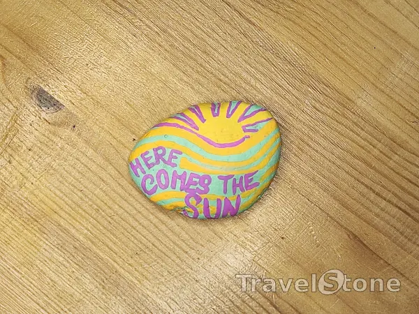 Painted painting stone by artist nad_doodles showing sayings. Here comes the sun