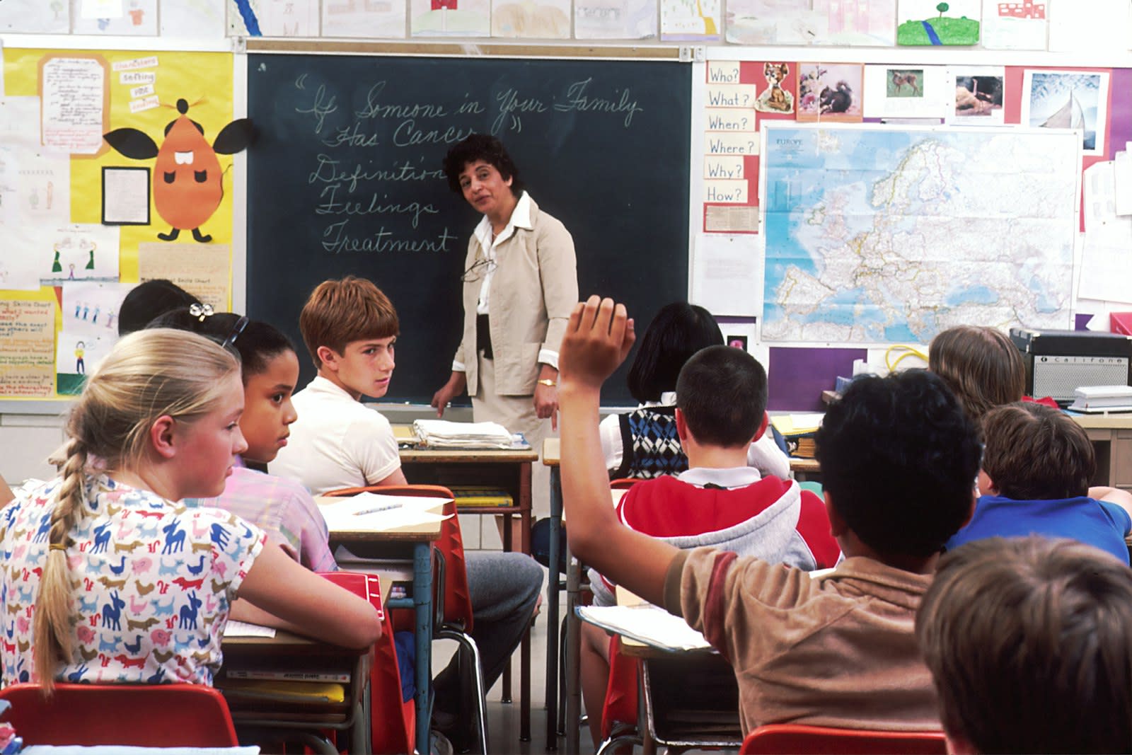 A classroom aide working with students